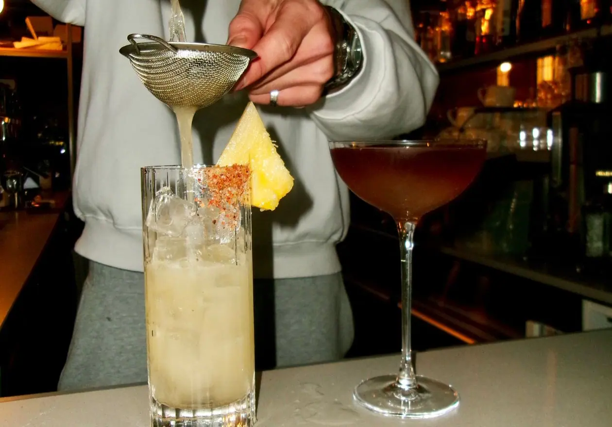 Cocktails being finished at the bar