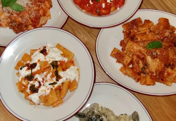 A spread of rigatoni with stracciatella and pasta dishes