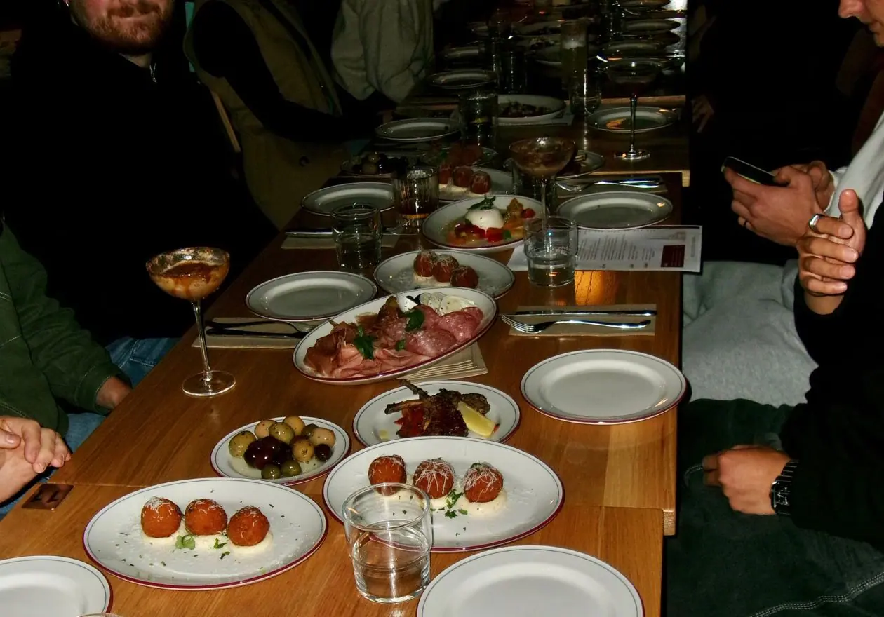 A long table of shared Italian plates at Quarter Two by Night
