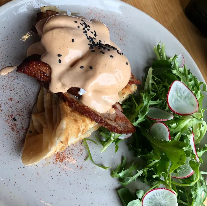 Mortadella benedict with rocket and radish