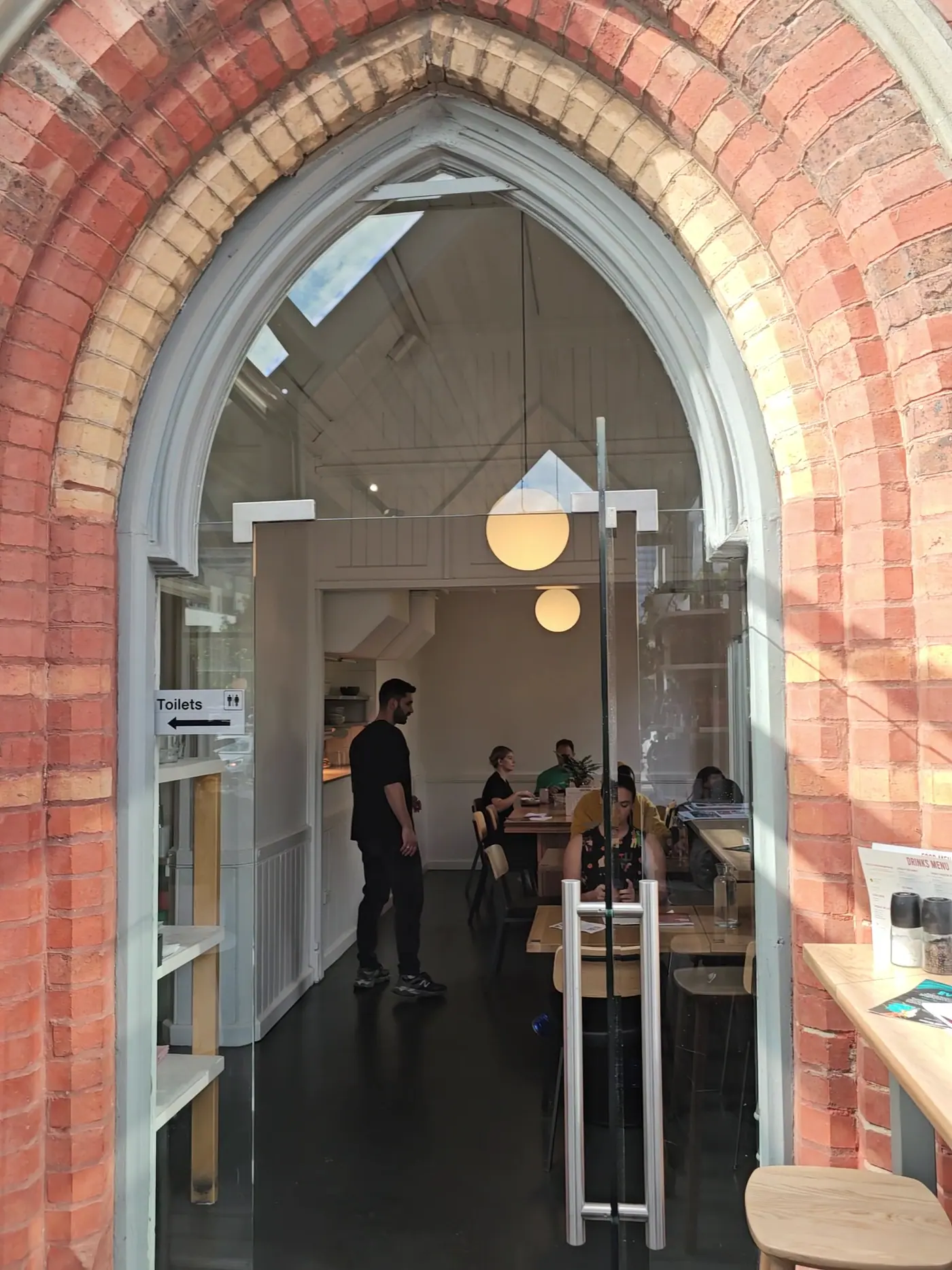 Inside the original Gothic arched doorway of the church, leading into the cafe